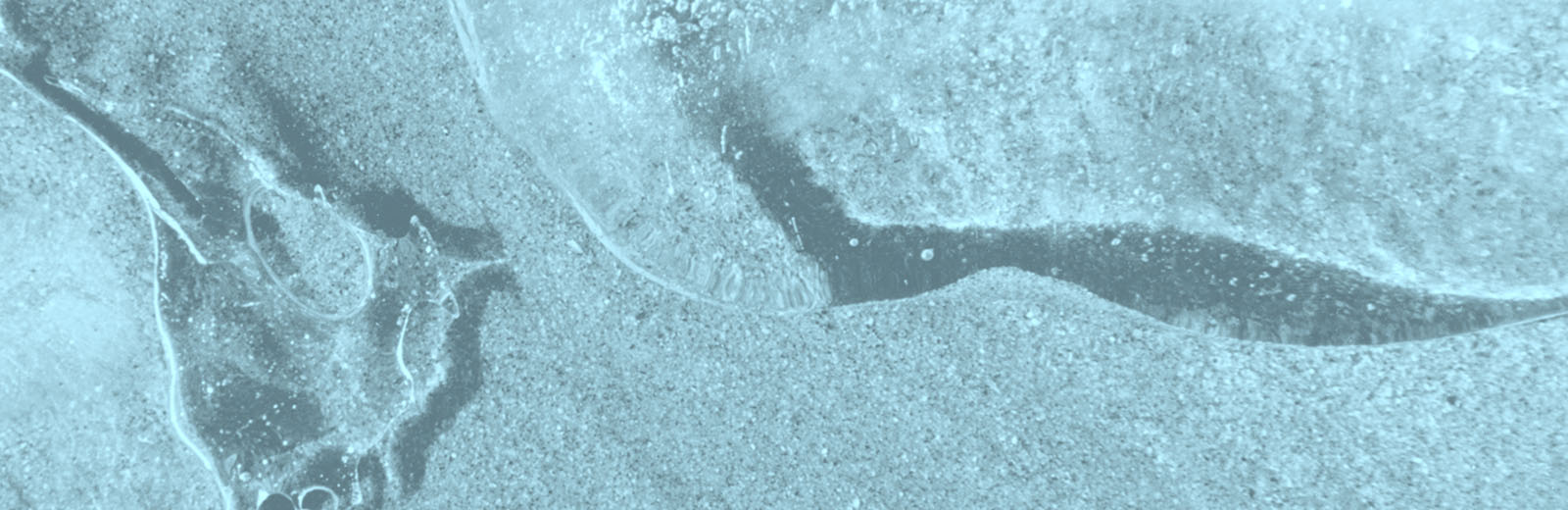 Water ripples across sand.